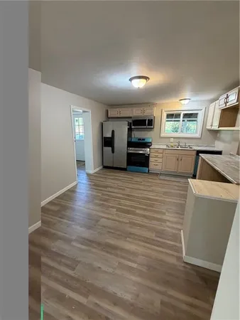 a kitchen with sink cabinets and microwave