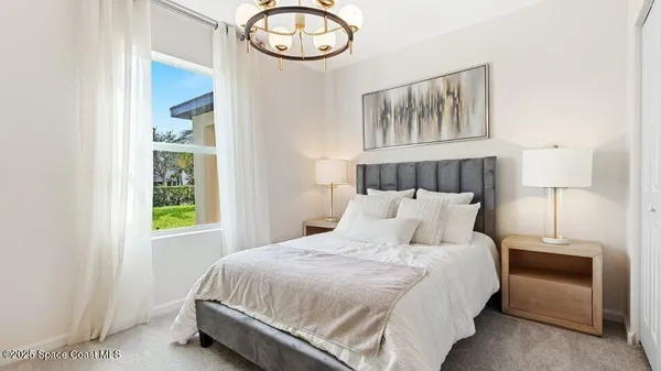 a bedroom with a bed and window