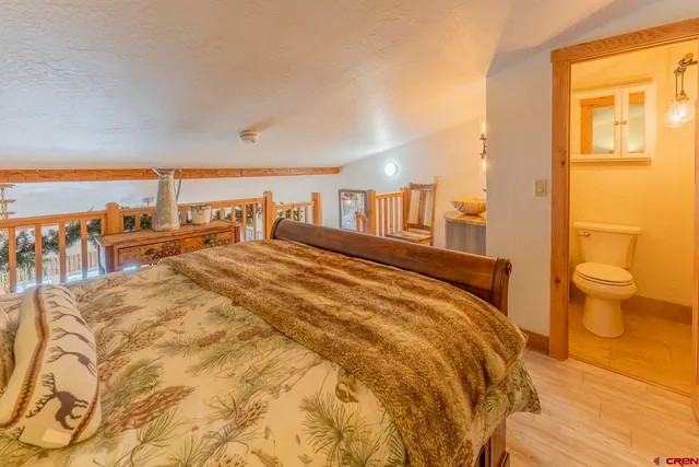 a spacious bedroom with a bed and a large window