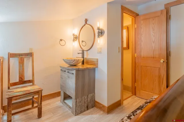 a room with mirror and a wooden door