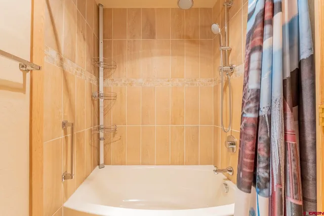 a bathroom with a tub and shower