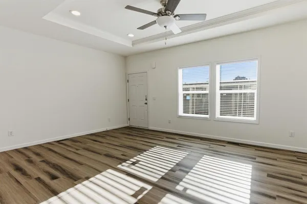 a view of a room with wooden floor and windows