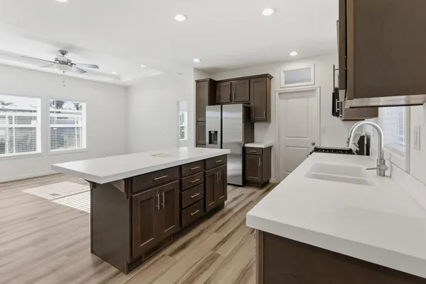 a kitchen with stainless steel appliances a sink stove and refrigerator