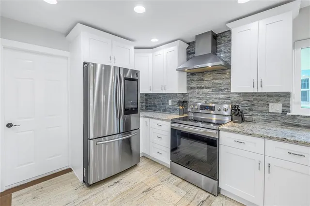 a view of a swimming pool with couches and a dining table with chairs