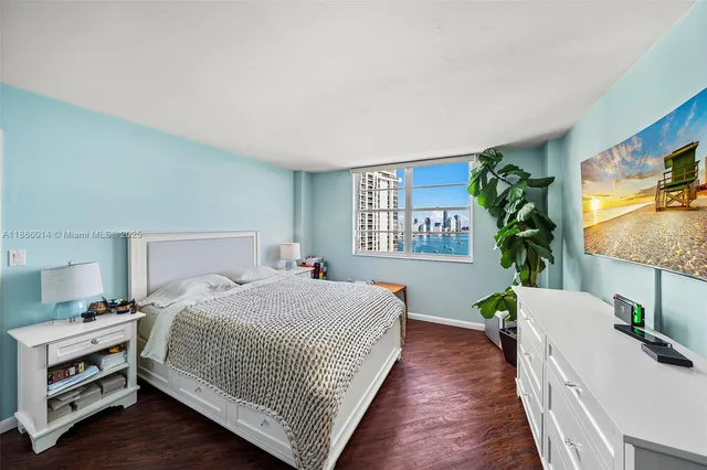 a bedroom with a bed and a potted plant