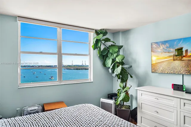 a bedroom with a bed and a potted plant