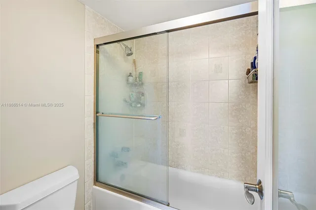 a bathroom with a glass shower door
