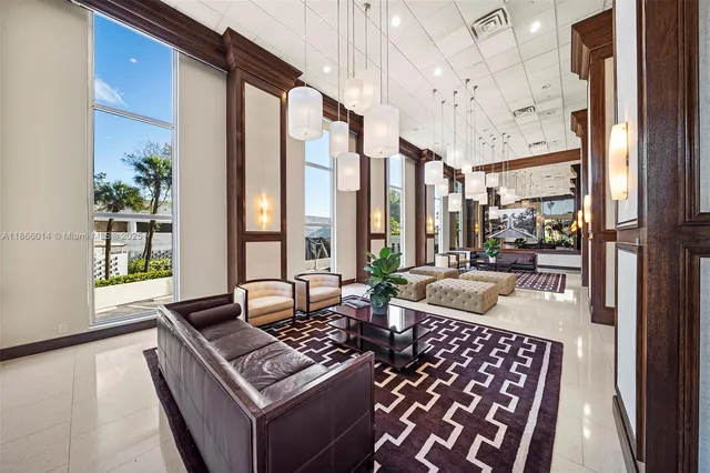 a living room with furniture and a floor to ceiling window