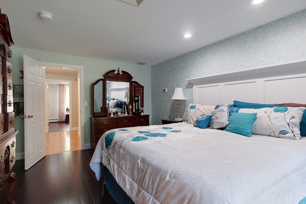 120 1/2 Lowell Road, Unit A Pepperell, MA 01463 - Photo 12 of 30 a bedroom with a large bed and a mirror