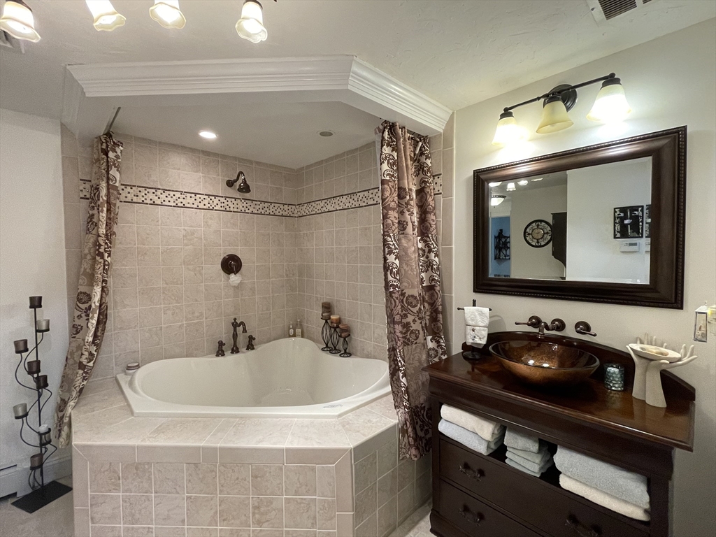 120 1/2 Lowell Road, Unit A Pepperell, MA 01463 - Photo 19 of 30 a bathroom with a sink and a mirror