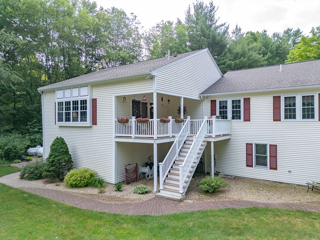 120 1/2 Lowell Road, Unit A Pepperell, MA 01463 - Photo 2 of 30 a view of a house with a yard