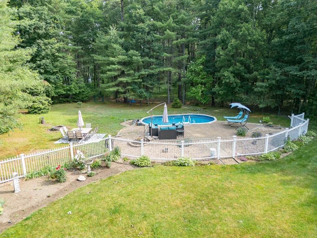 120 1/2 Lowell Road, Unit A Pepperell, MA 01463 - Photo 23 of 30 a view of a lake with a yard and furniture