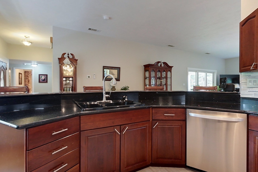 120 1/2 Lowell Road, Unit A Pepperell, MA 01463 - Photo 3 of 30 a kitchen with granite countertop a sink and cabinets