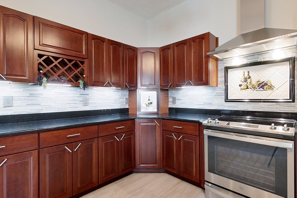 120 1/2 Lowell Road, Unit A Pepperell, MA 01463 - Photo 4 of 30 a kitchen with wooden cabinets and a stove top oven