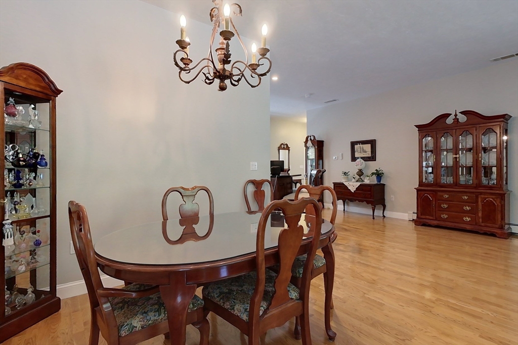 120 1/2 Lowell Road, Unit A Pepperell, MA 01463 - Photo 7 of 30 a view of a dining room with furniture and wooden floor