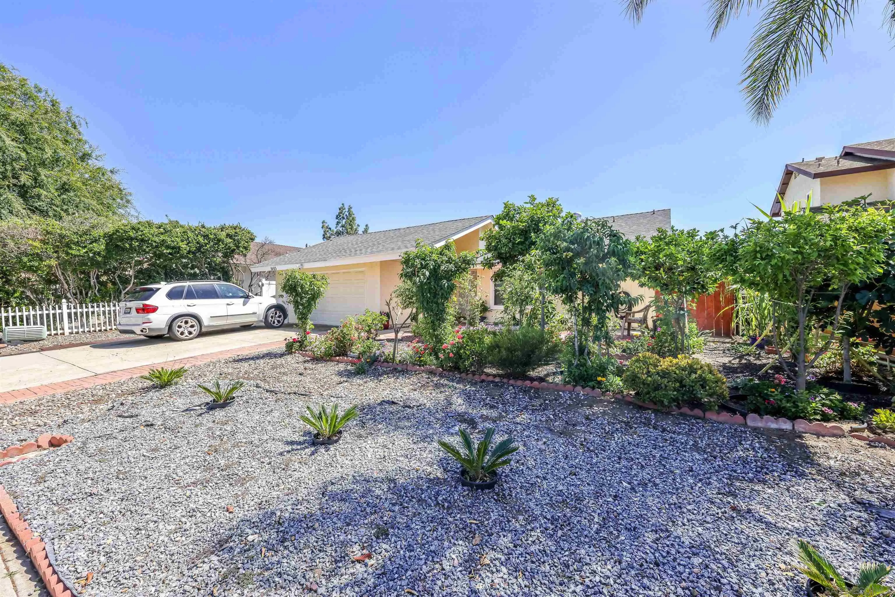 14513 Mirando Street Poway, CA 92064 - Photo 18 of 25 a white house with trees in front of it