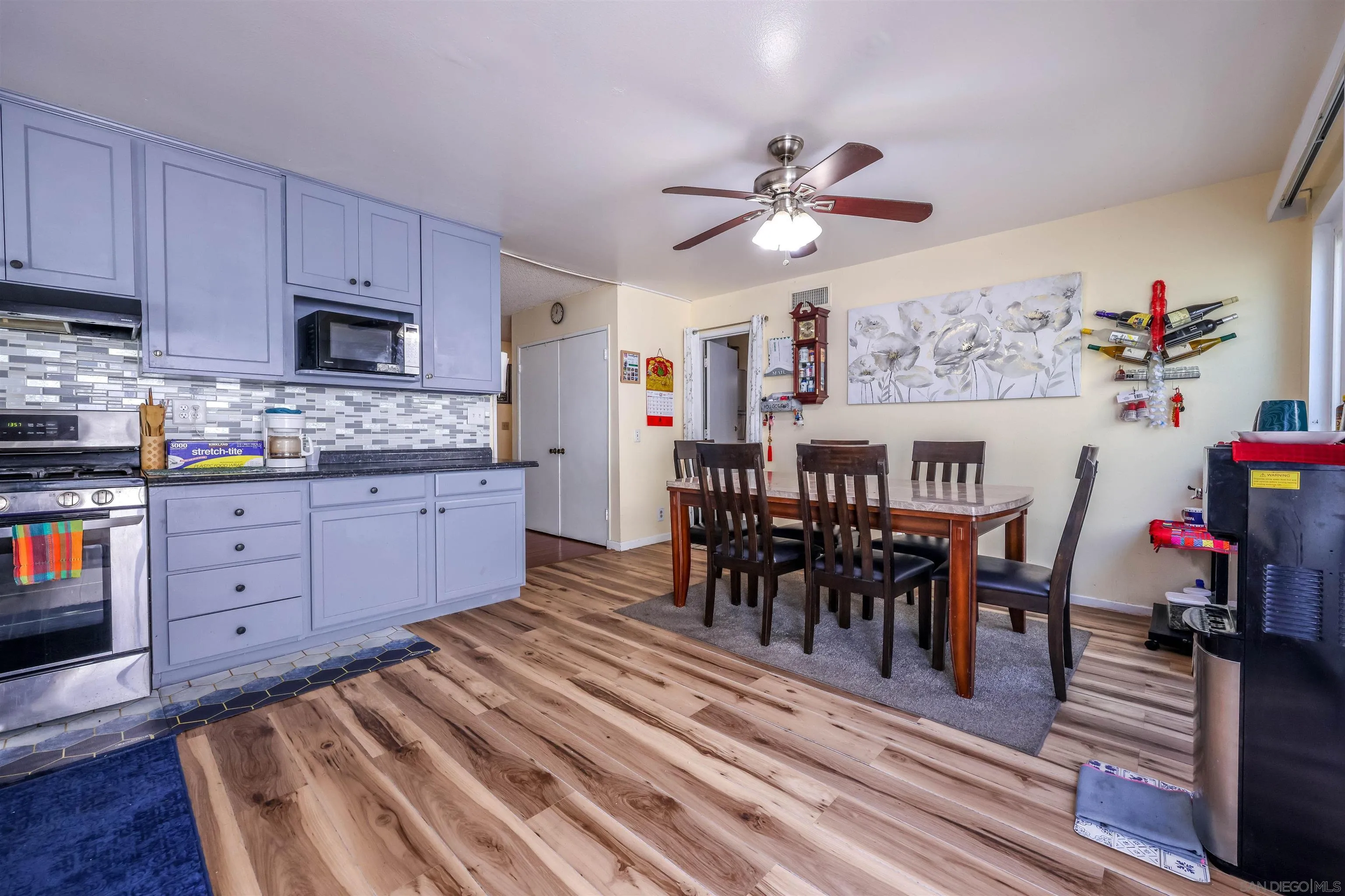 14513 Mirando Street Poway, CA 92064 - Photo 4 of 25 a view of dining room and kitchen with furniture wooden floor and a rug