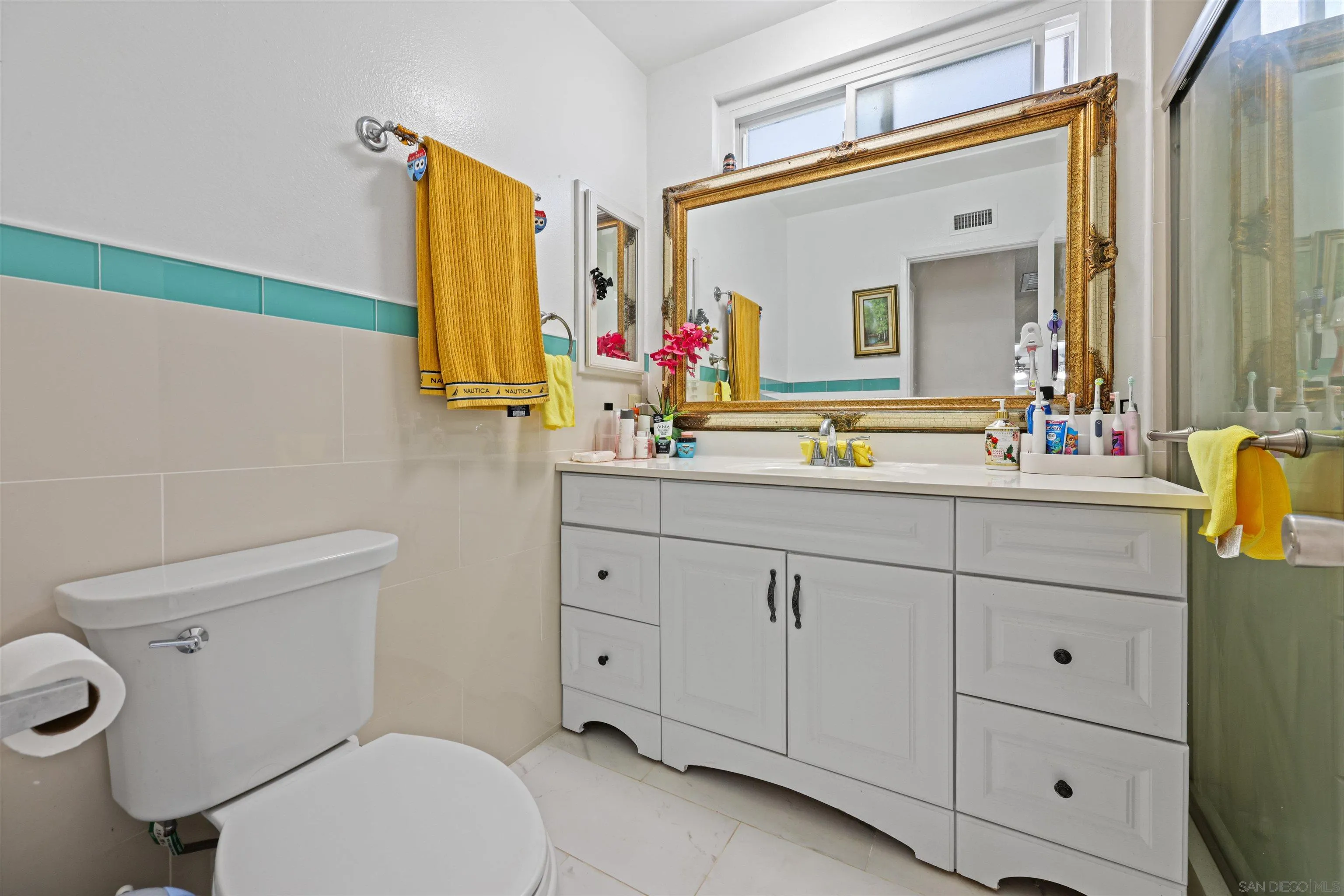 14513 Mirando Street Poway, CA 92064 - Photo 10 of 25 a bathroom with a toilet sink vanity and mirror