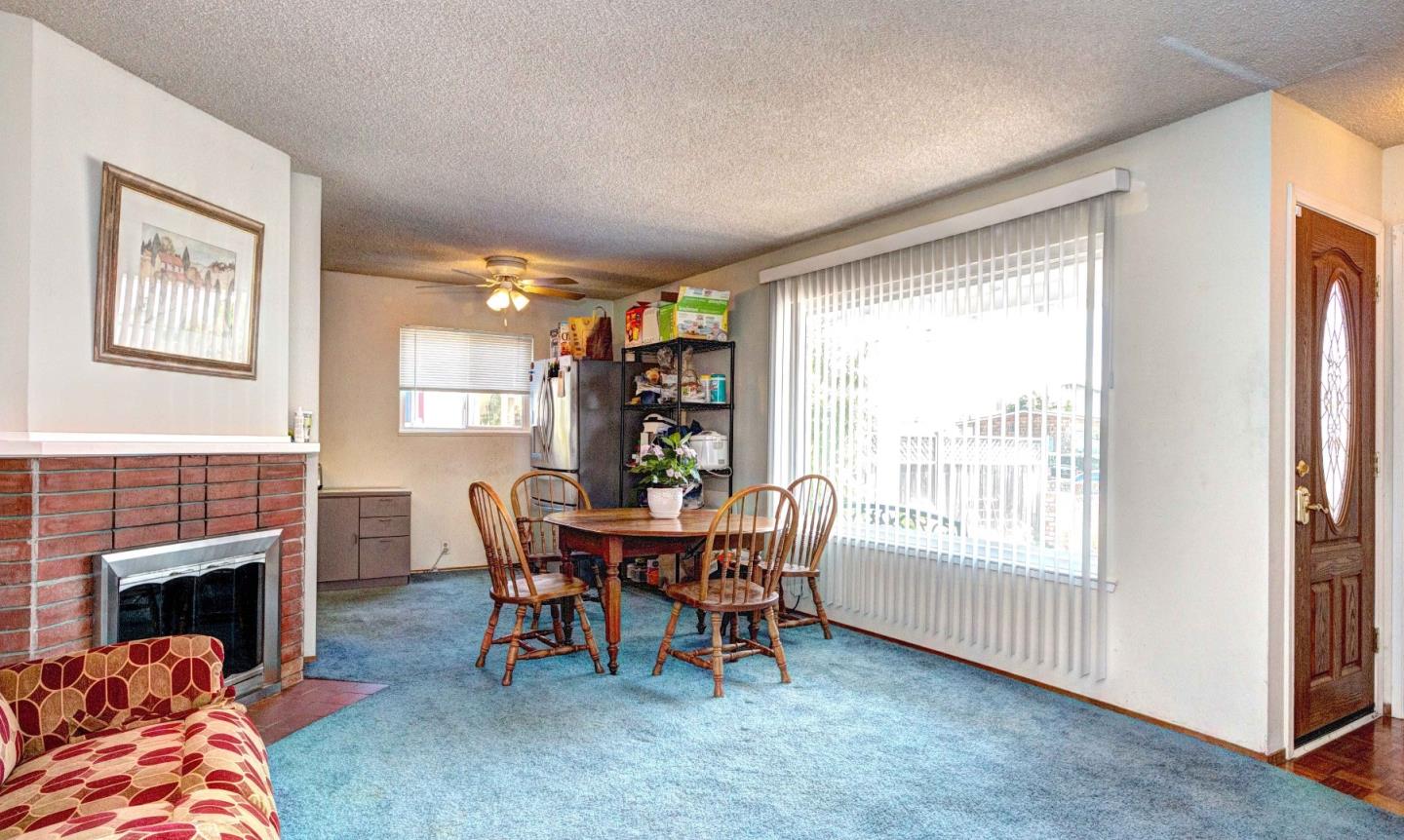 1614 Roberta Drive San Mateo, CA 94403 - Photo 3 of 6 a dining room with furniture and a fireplace