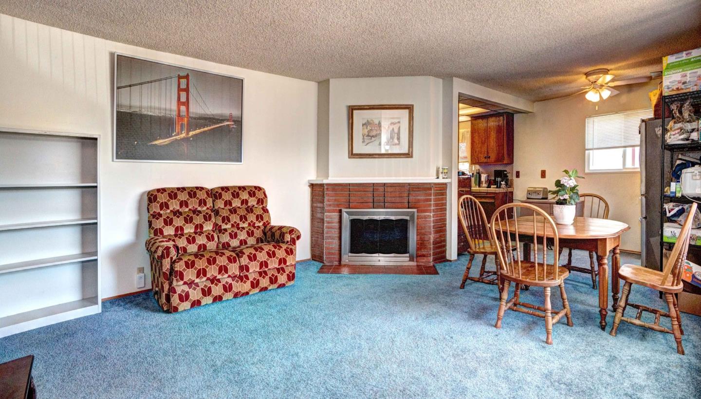 1614 Roberta Drive San Mateo, CA 94403 - Photo 6 of 6 a living room with furniture a fireplace and a flat screen tv