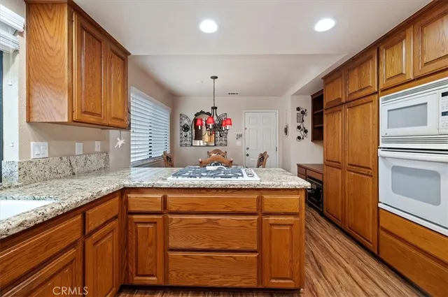 a kitchen with wooden floors and wooden cabinets
