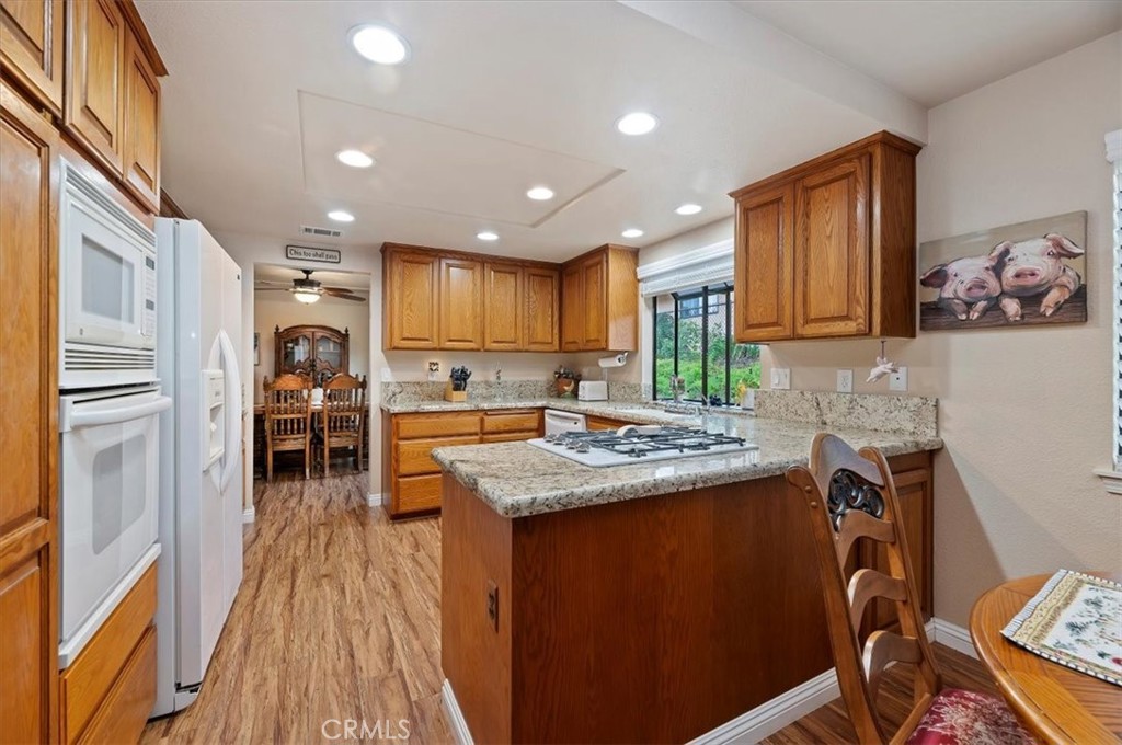 1168 North Crescent Ridge Road Fallbrook, CA 92028 - Photo 19 of 45 a kitchen with stainless steel appliances granite countertop a refrigerator a stove top oven a sink and dishwasher