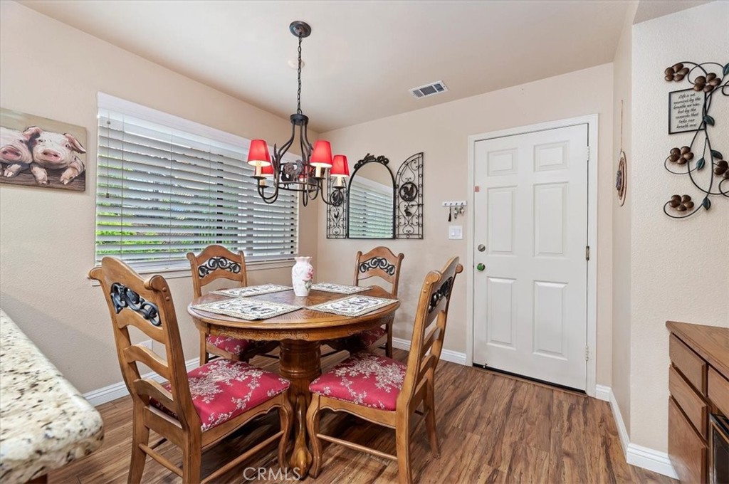 1168 North Crescent Ridge Road Fallbrook, CA 92028 - Photo 20 of 45 a dining room with furniture and wooden floor