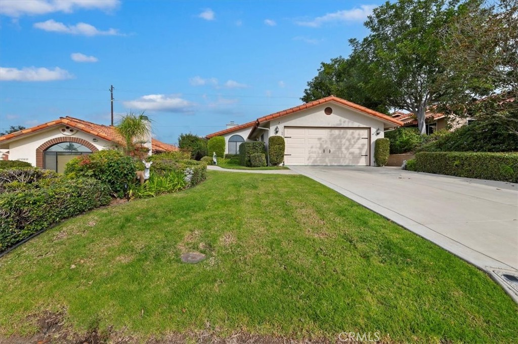 1168 North Crescent Ridge Road Fallbrook, CA 92028 - Photo 2 of 45 a front view of a house with a yard and garage