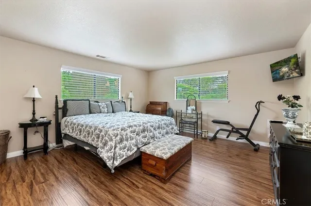 a bedroom with a bed and wooden floor