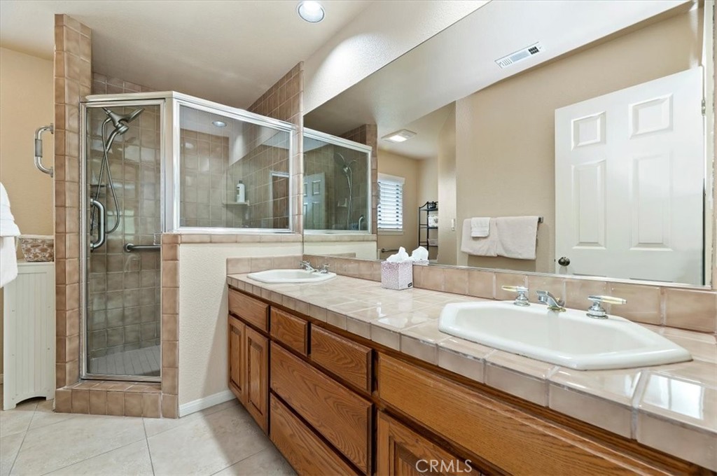 1168 North Crescent Ridge Road Fallbrook, CA 92028 - Photo 28 of 45 a bathroom with a granite countertop sink mirror and double