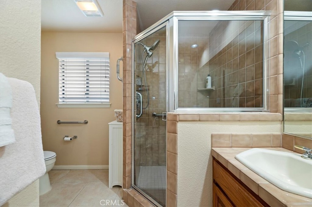1168 North Crescent Ridge Road Fallbrook, CA 92028 - Photo 29 of 45 a bathroom with a sink a toilet and shower