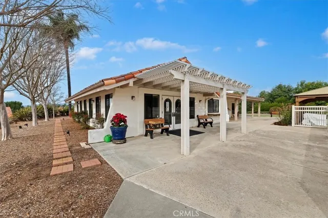 a view of a tennis ground with large trees