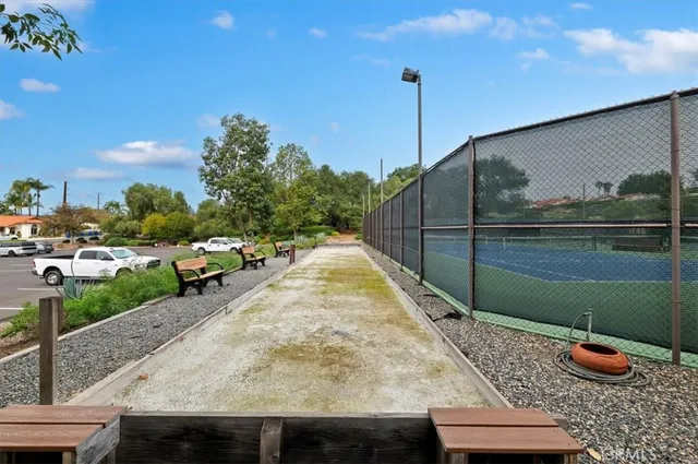 a view of a backyard with potted plants and large tree