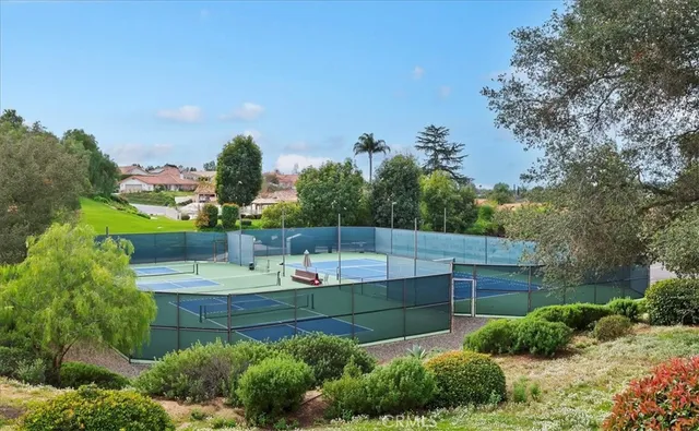 a view of a field of grass and trees