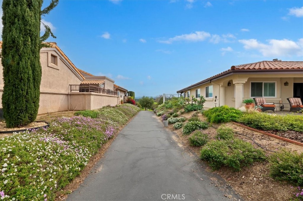 1168 North Crescent Ridge Road Fallbrook, CA 92028 - Photo 43 of 45 a view of a house with a yard and potted plants