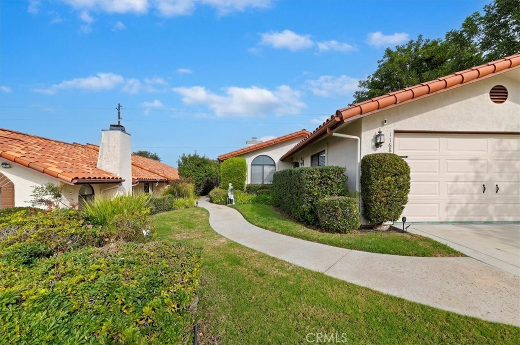 1168 North Crescent Ridge Road Fallbrook, CA 92028 - Photo 5 of 45 a front view of a house with a yard and potted plants