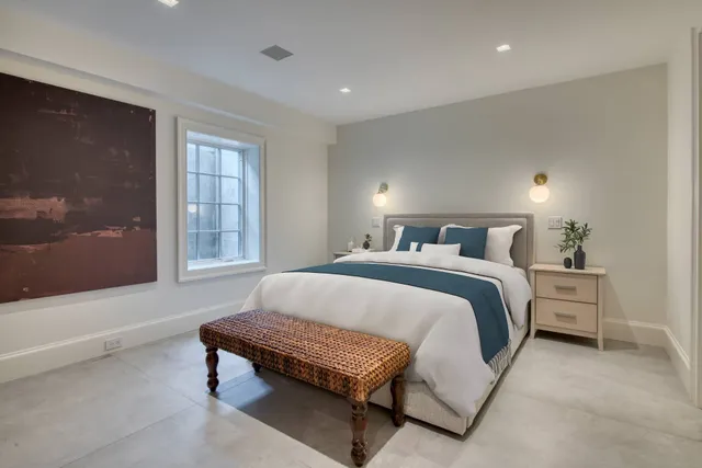 a bedroom with a bed and window