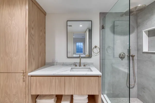 a bathroom with a granite countertop sink and a mirror