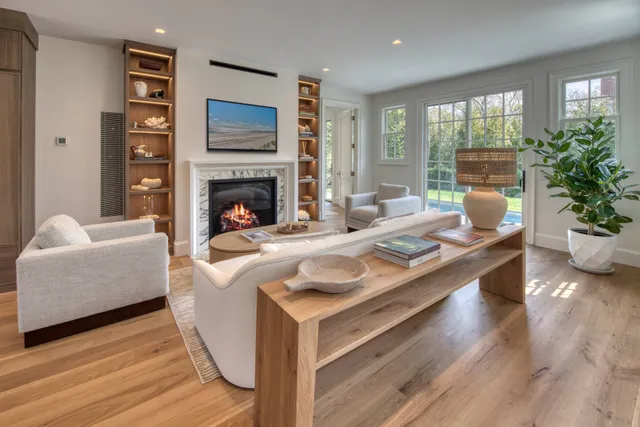 a living room with furniture fireplace and window
