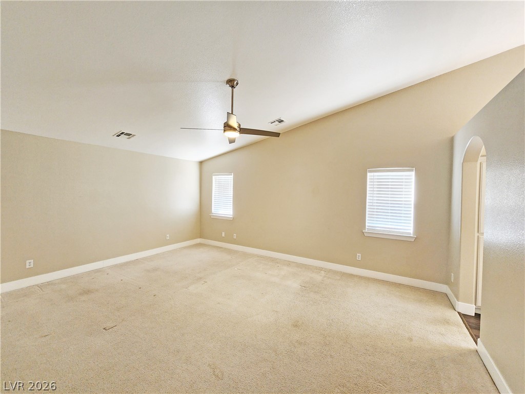 4591 Stoneham Street Pahrump, NV 89061 - Photo 23 of 42 A spacious room offers comfortable carpet flooring and abundant natural light from multiple windows.