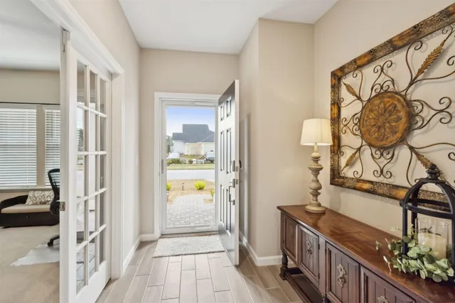 a kitchen with stainless steel appliances granite countertop white cabinets a microwave a sink and dishwasher