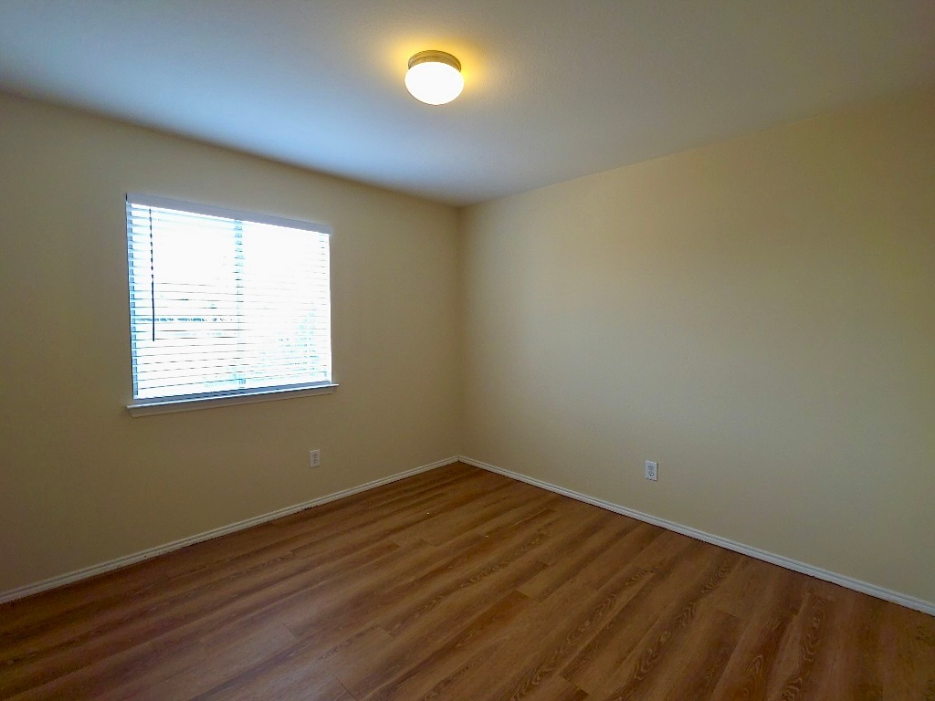 204 Ruby Lake Drive Kyle, TX 78640 - Photo 18 of 22 Bedroom featuring baseboards and wood-style floors