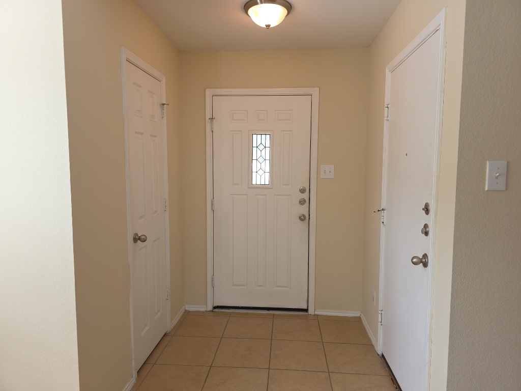 204 Ruby Lake Drive Kyle, TX 78640 - Photo 3 of 22 Foyer entrance featuring baseboards and light tile patterned floors