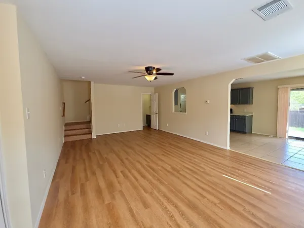 a view of empty room with wooden floor