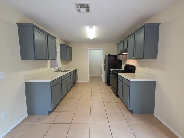 a large kitchen with stainless steel appliances lots of counter top space