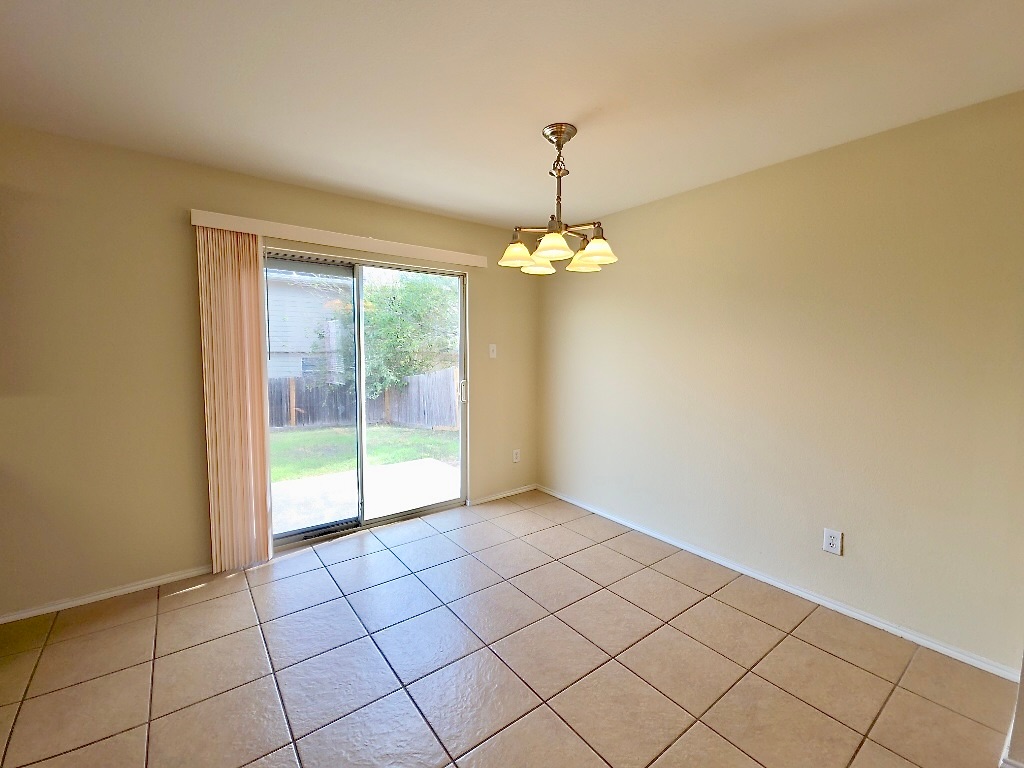 204 Ruby Lake Drive Kyle, TX 78640 - Photo 7 of 22 Dining area with light tile flooring and access to the backyard