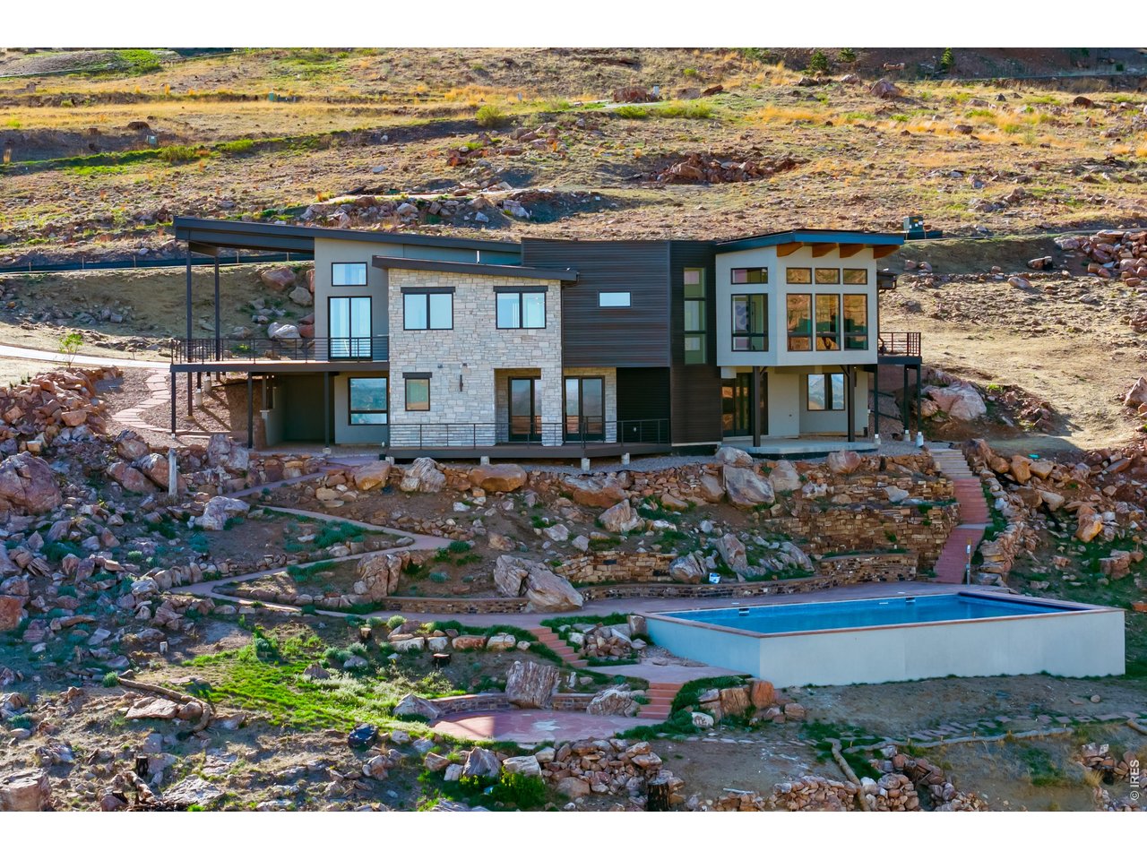 9578 Mountain Ridge Drive Boulder, CO 80302 - Photo 47 of 47 a view of a lake with a building and trees all around