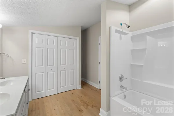 a bathroom with a bathtub and a shower