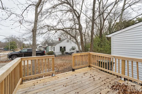a view of a house with wooden fence