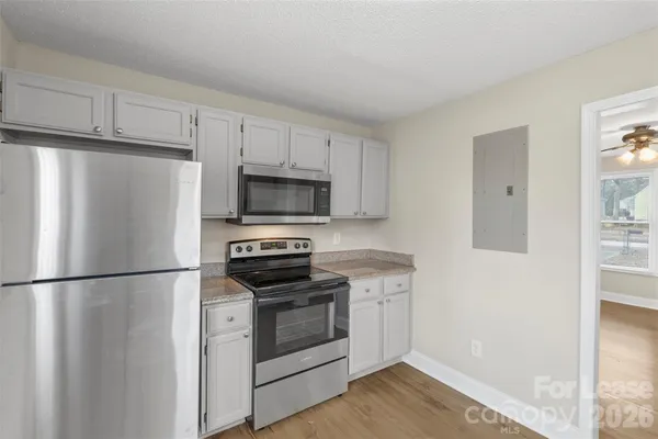 a kitchen with stainless steel appliances a refrigerator stove and microwave